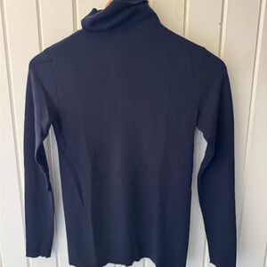Leetha timeless cashmere turtleneck gold chain detail